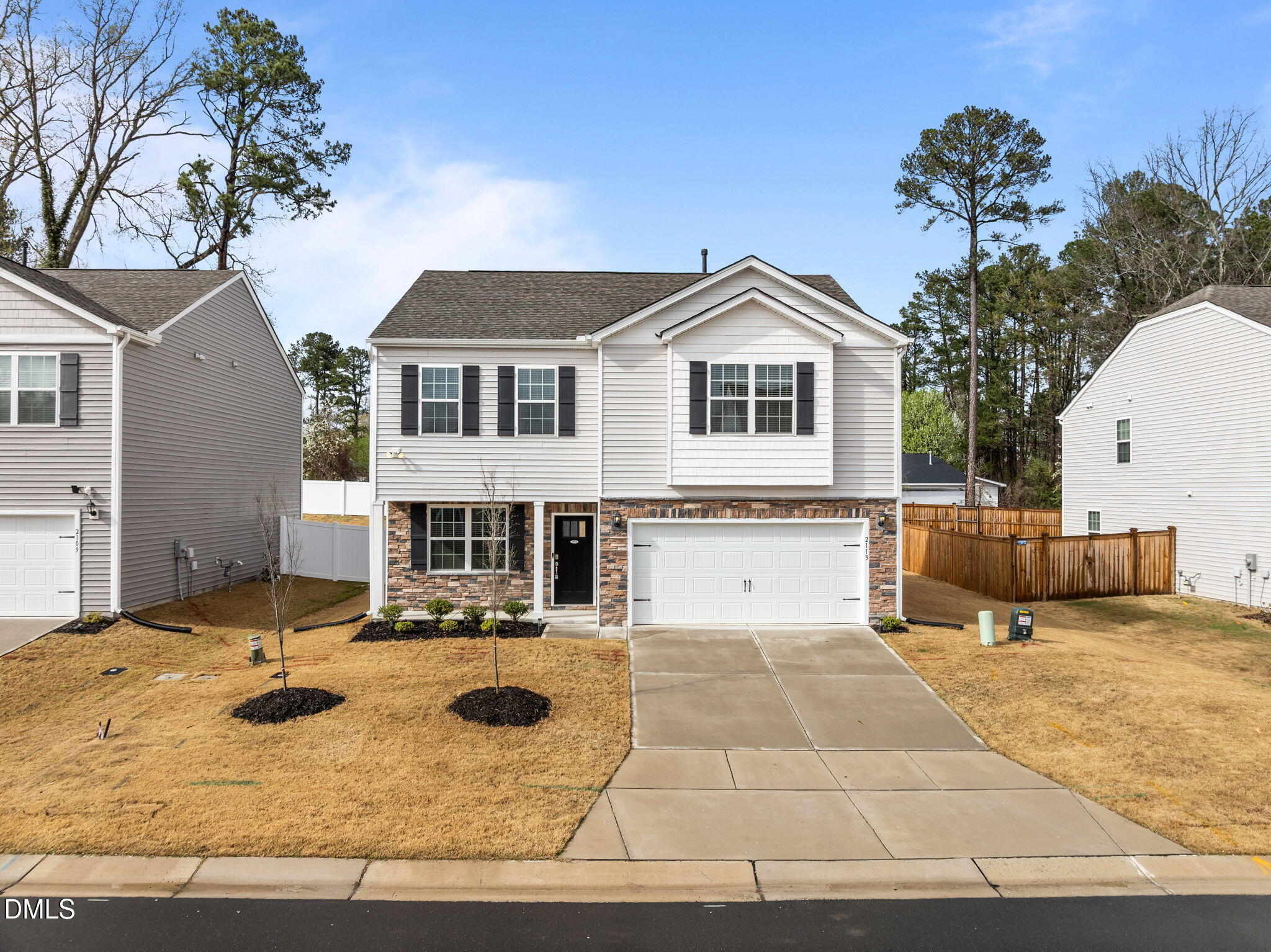 2113 Fletchers Ridge Drive Durham, NC 27703 - Photo 53 of 54 a view of a house with snow on the wall and trees in the background
