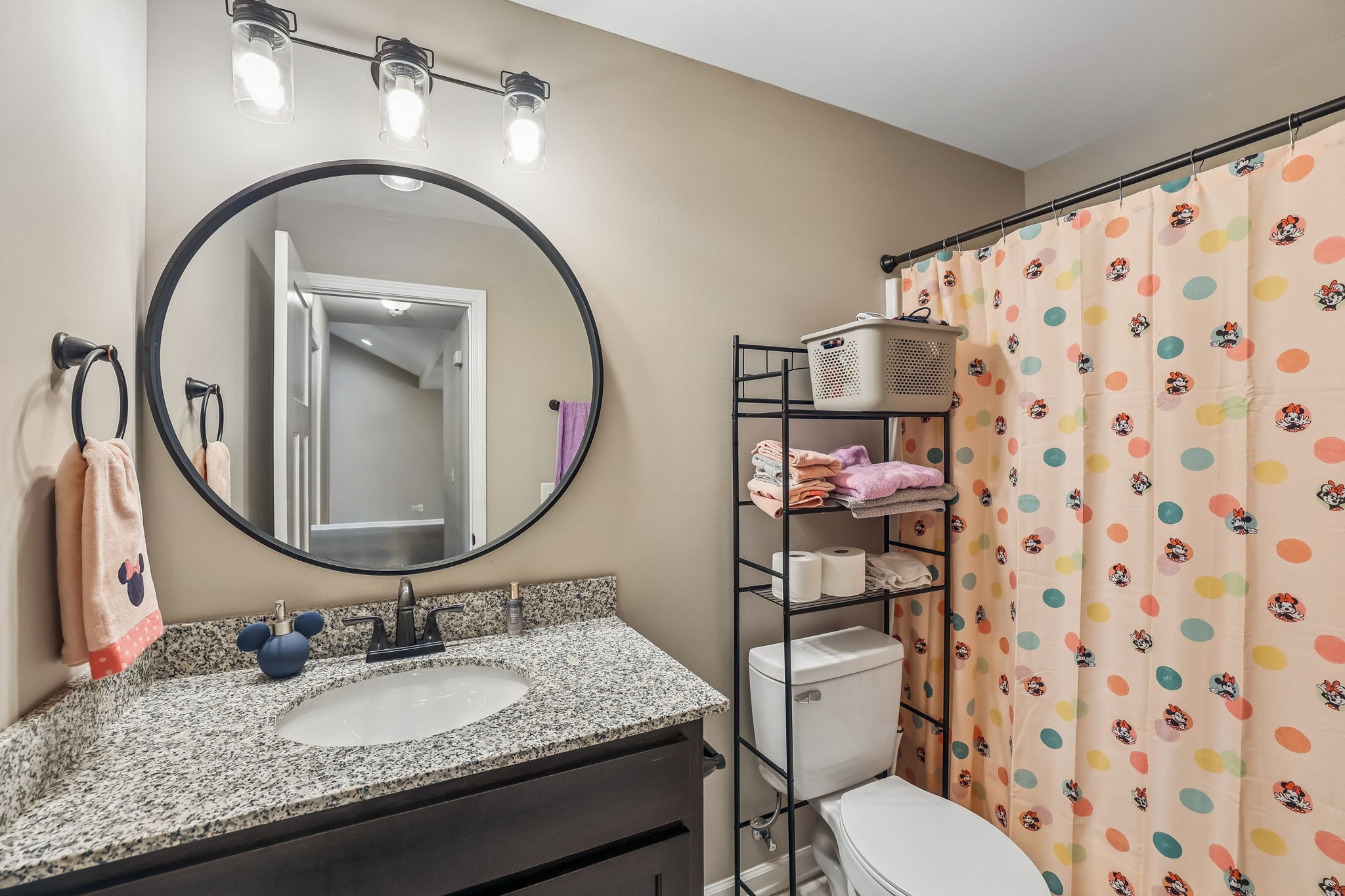 1546 South Spring Street Manchester, TN 37355 - Photo 32 of 53 a bathroom with a granite countertop toilet a sink and a mirror
