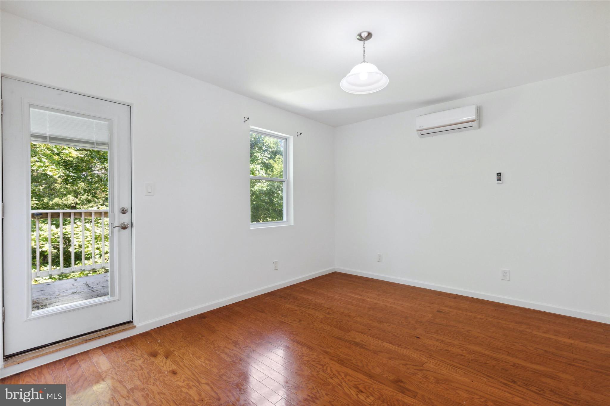 997 Camp Road Telford, PA 18969 - Photo 11 of 25 an empty room with wooden floor and windows