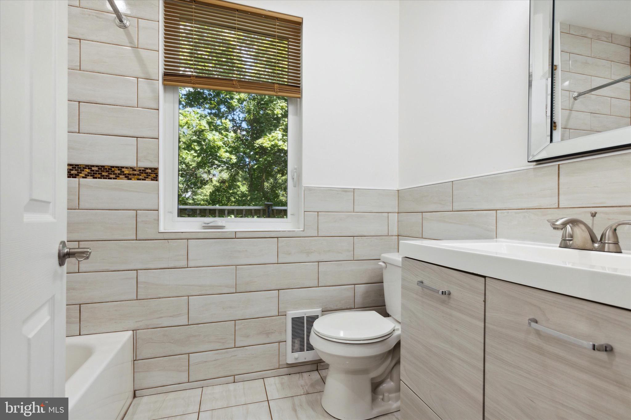 997 Camp Road Telford, PA 18969 - Photo 13 of 25 a bathroom with a toilet a sink and window