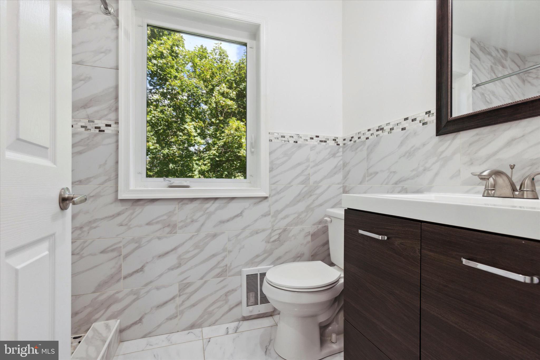 997 Camp Road Telford, PA 18969 - Photo 19 of 25 a bathroom with a sink a toilet and a mirror