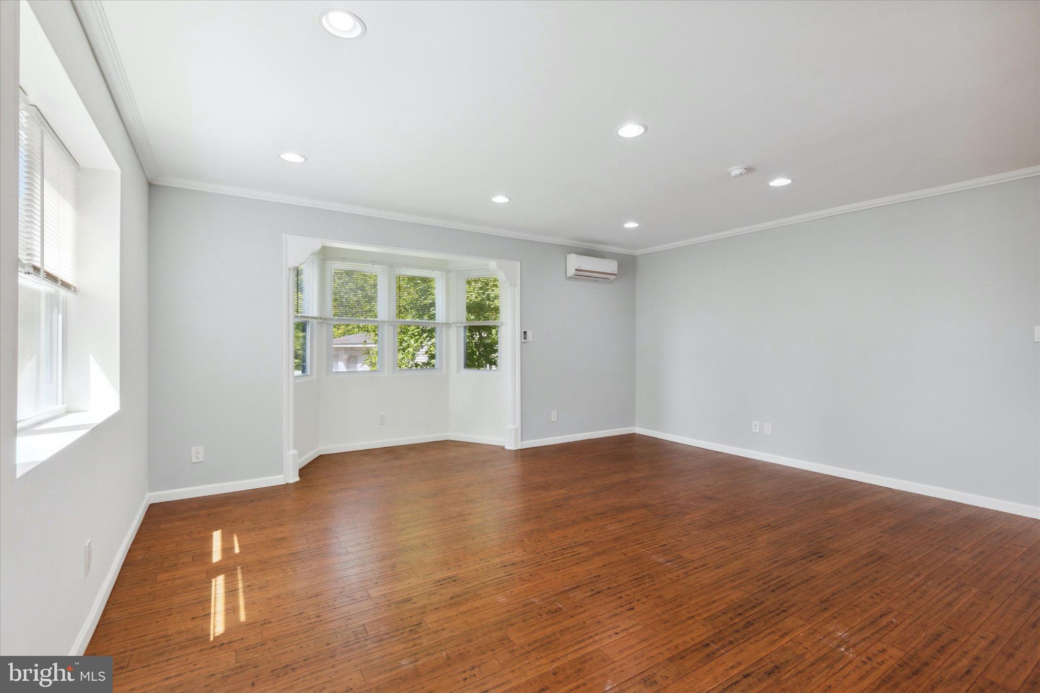 997 Camp Road Telford, PA 18969 - Photo 7 of 25 an empty room with wooden floor and windows