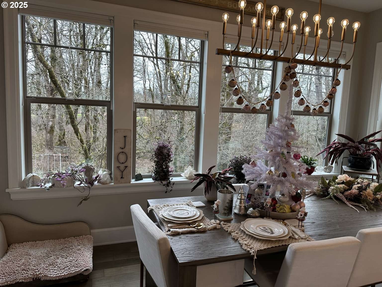 7535 Northwest Quinault Street Camas, WA 98607 - Photo 7 of 27 a view of a dining room with furniture large windows and wooden floor