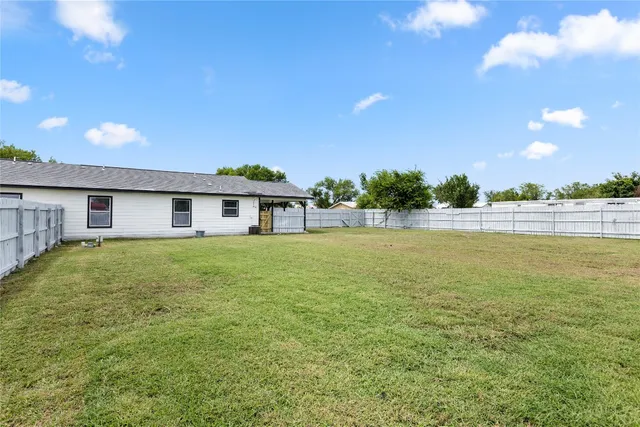 a front view of house with yard and lake