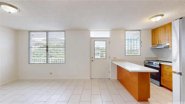 a view of a kitchen with furniture and windows