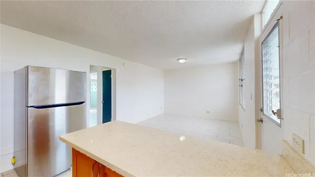 a view of kitchen with refrigerator and wooden floor