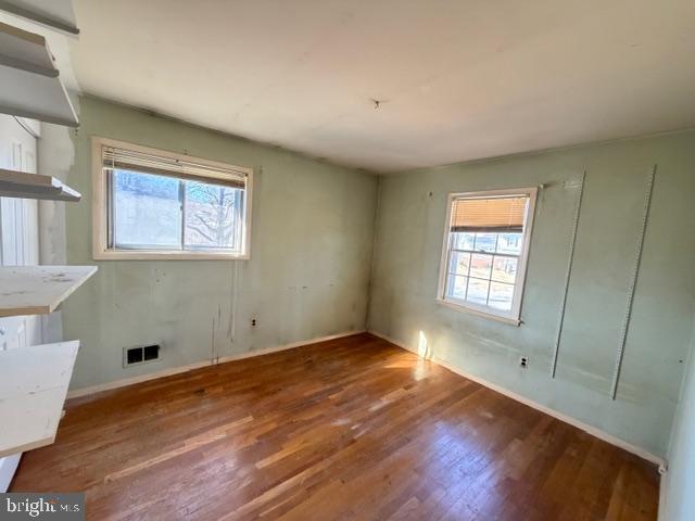 8909 Keewatin Road Lanham, MD 20706 - Photo 11 of 18 a view of an empty room with a window and wooden floor