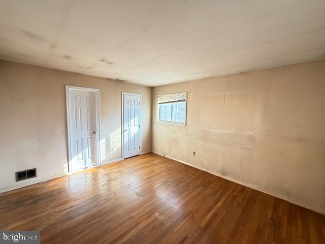 8909 Keewatin Road Lanham, MD 20706 - Photo 15 of 18 a view of an empty room with wooden floor and a window