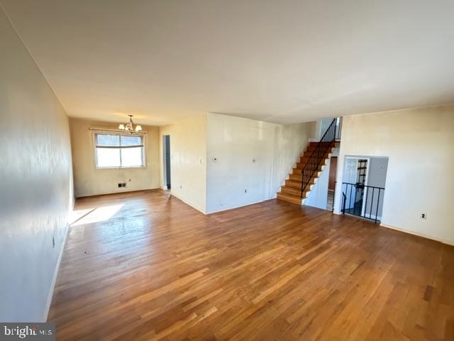 8909 Keewatin Road Lanham, MD 20706 - Photo 2 of 18 a view of empty room with wooden floor and window
