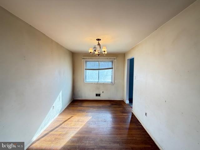 8909 Keewatin Road Lanham, MD 20706 - Photo 4 of 18 a view of an empty room with wooden floor and a window
