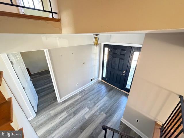 8909 Keewatin Road Lanham, MD 20706 - Photo 5 of 18 a view of a livingroom with wooden floor and staircase