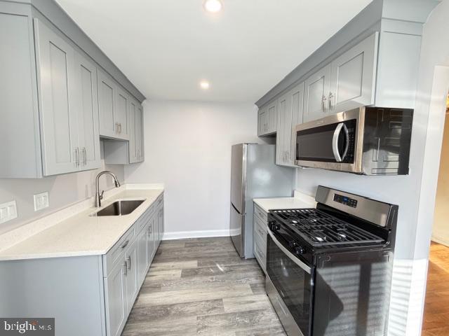 8909 Keewatin Road Lanham, MD 20706 - Photo 7 of 18 a kitchen with stainless steel appliances granite countertop a sink stove and refrigerator