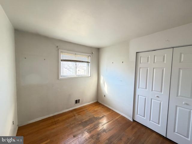8909 Keewatin Road Lanham, MD 20706 - Photo 10 of 18 an empty room with wooden floor and windows
