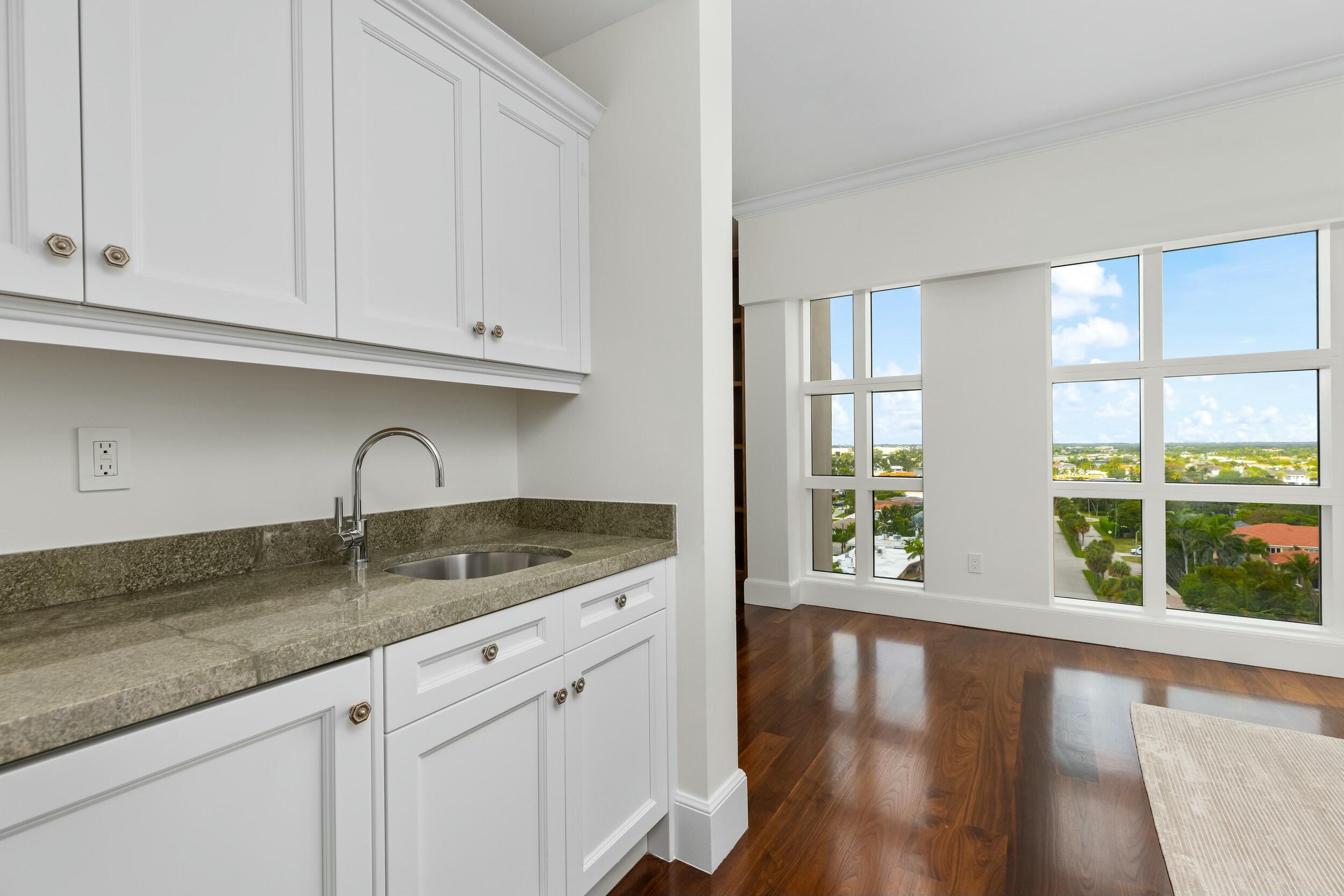 2500 South Ocean Boulevard, Unit 903 Boca Raton, FL 33432 - Photo 25 of 66 a kitchen with granite countertop a sink window and cabinets