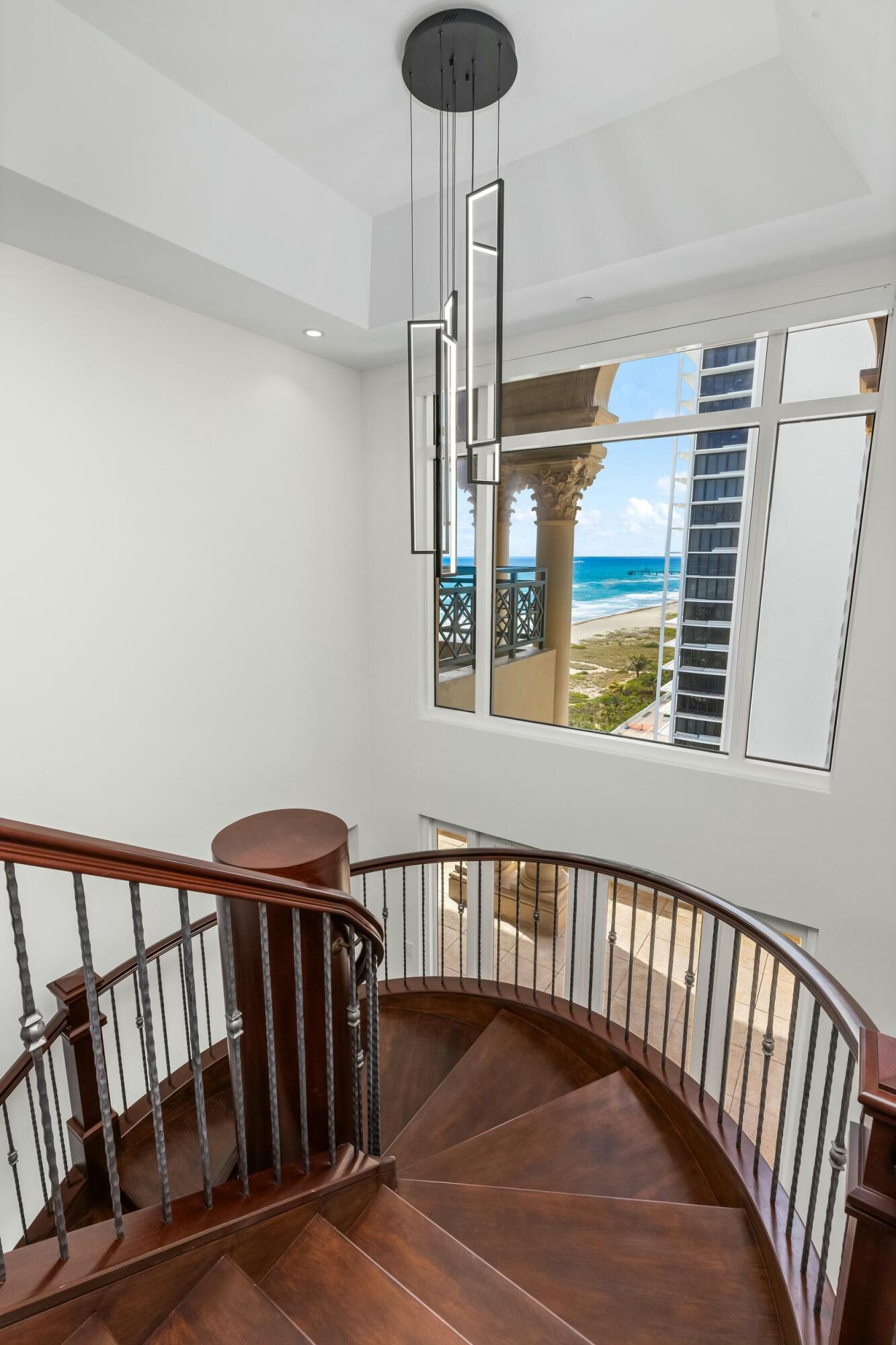 2500 South Ocean Boulevard, Unit 903 Boca Raton, FL 33432 - Photo 28 of 66 a view of staircase with railing and a chandelier