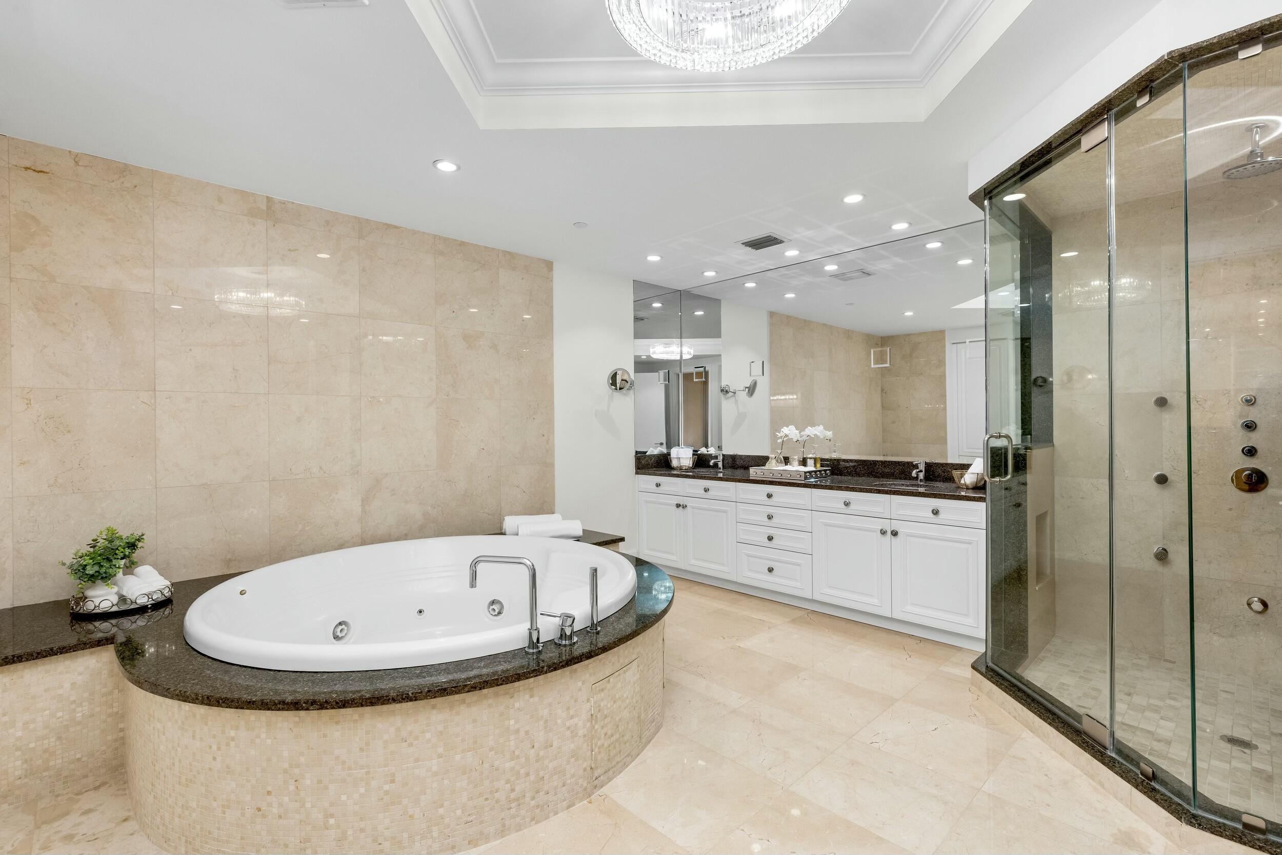 2500 South Ocean Boulevard, Unit 903 Boca Raton, FL 33432 - Photo 37 of 66 a bathroom with a tub sink and mirror