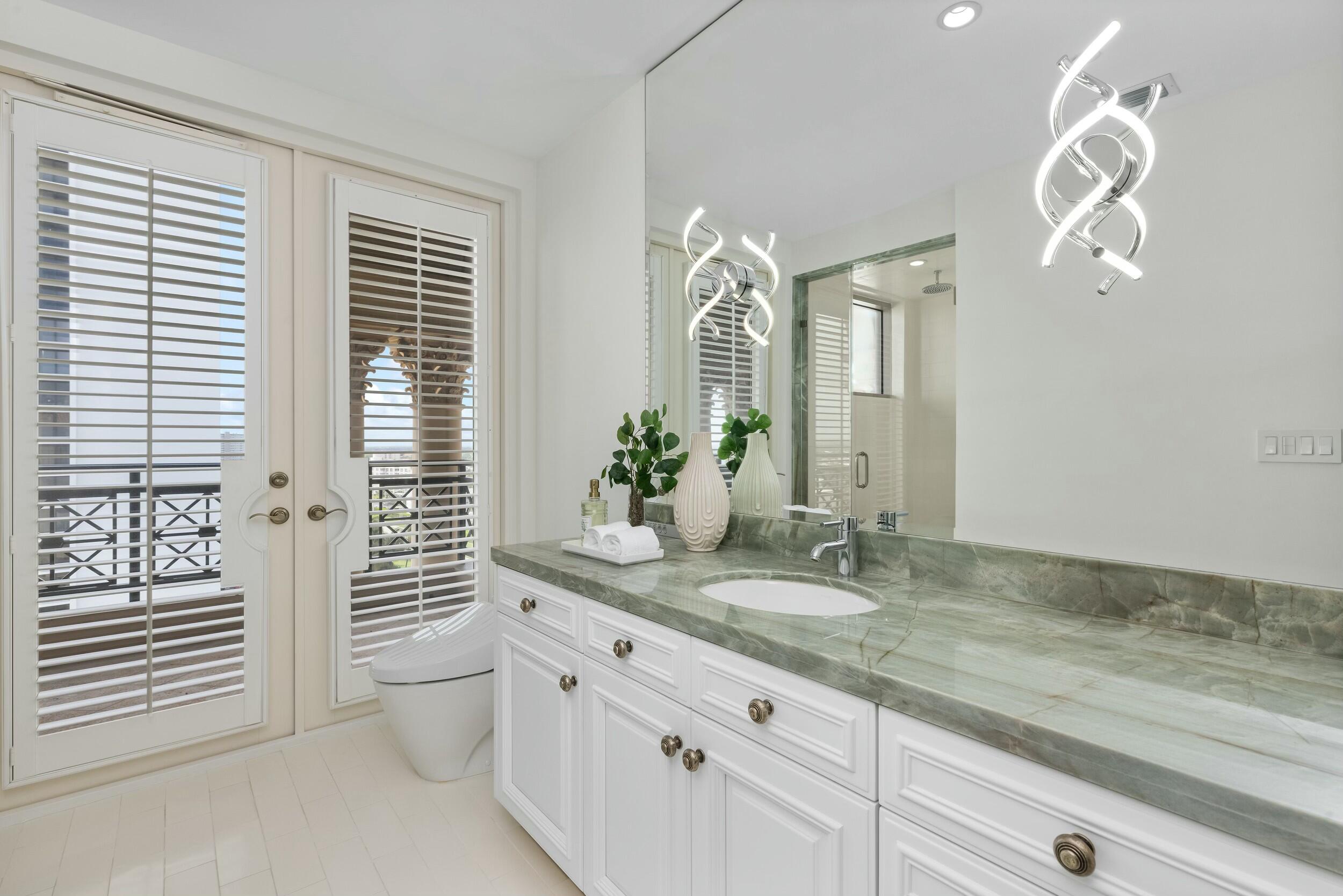 2500 South Ocean Boulevard, Unit 903 Boca Raton, FL 33432 - Photo 43 of 66 a bathroom with a granite countertop sink and a mirror