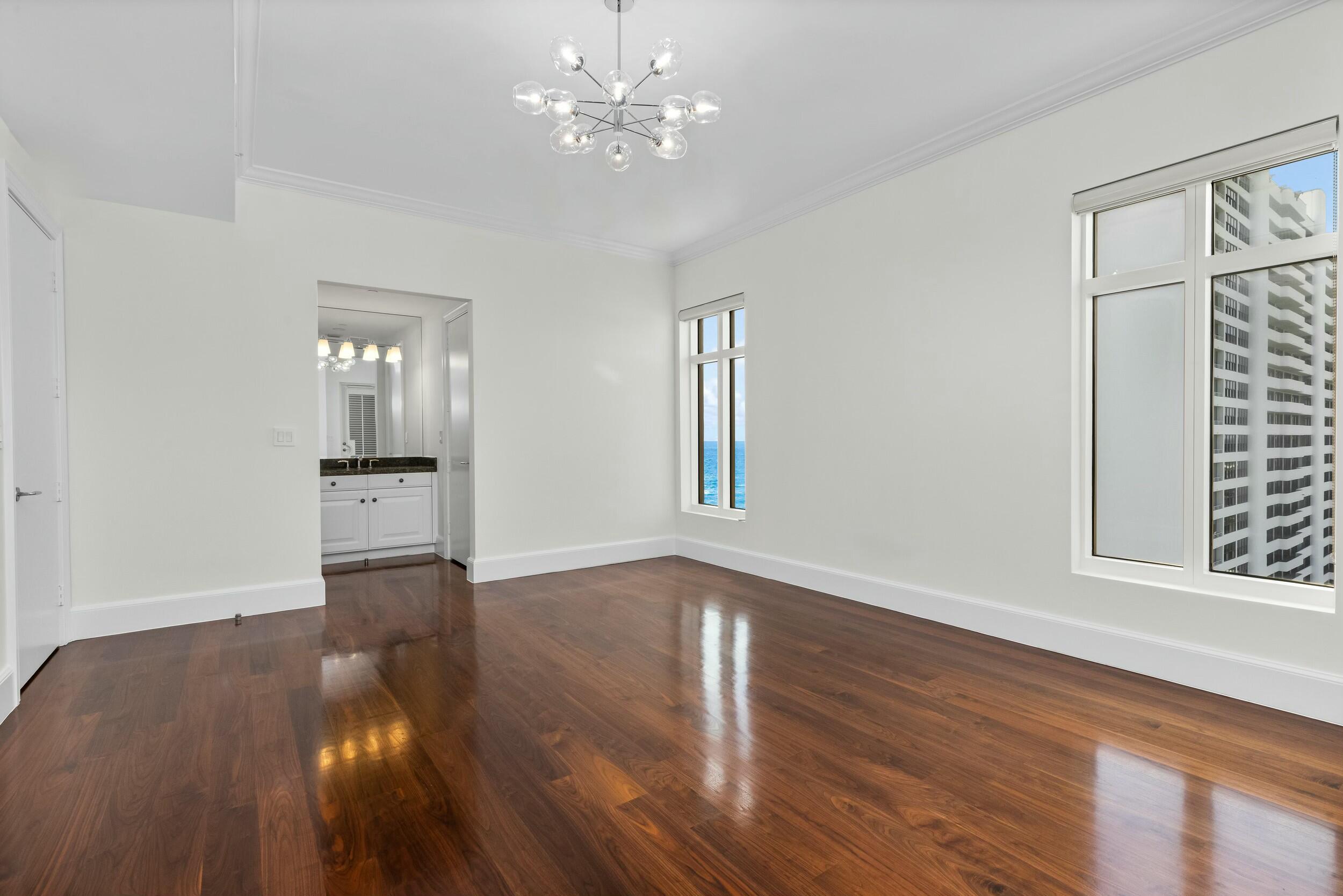 2500 South Ocean Boulevard, Unit 903 Boca Raton, FL 33432 - Photo 47 of 66 a view of an empty room with wooden floor and a window