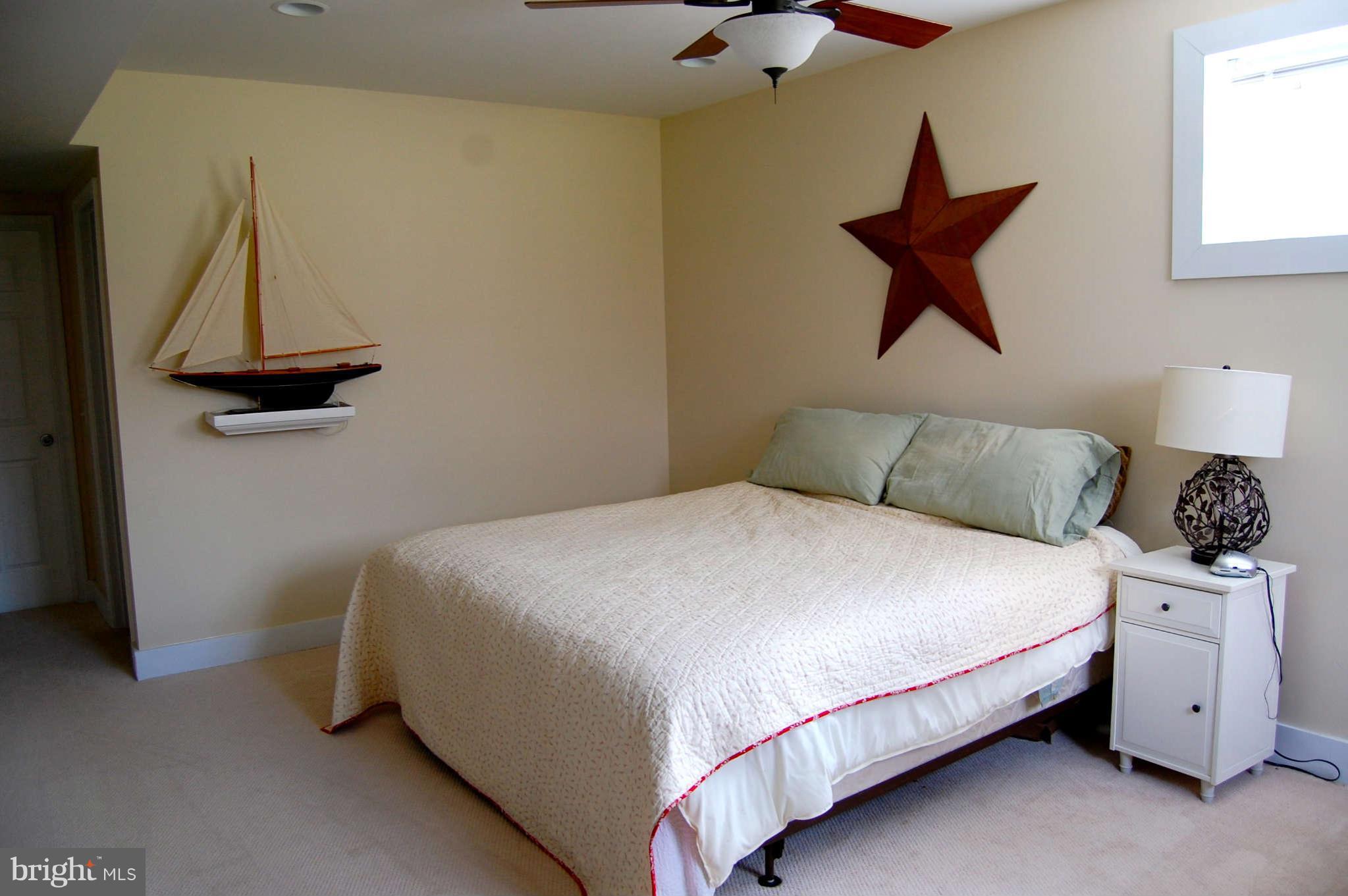 407 Stringtown Road Berryville, VA 22611 - Photo 22 of 30 a bedroom with a bed and a potted plant on the dresser