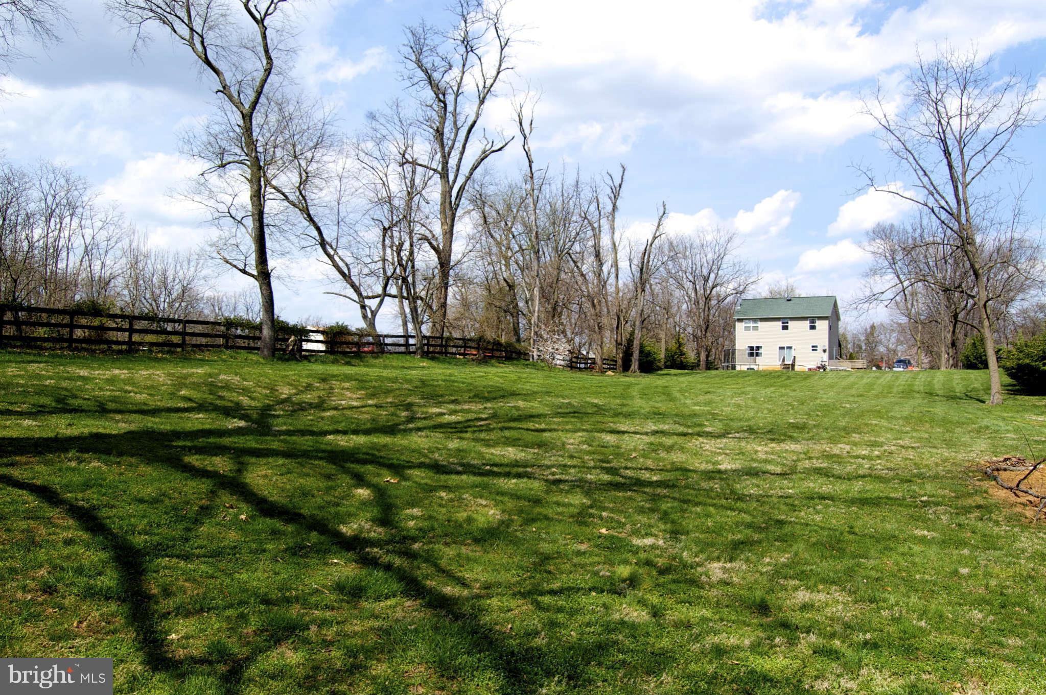 407 Stringtown Road Berryville, VA 22611 - Photo 4 of 30 a backyard of apartments with large trees