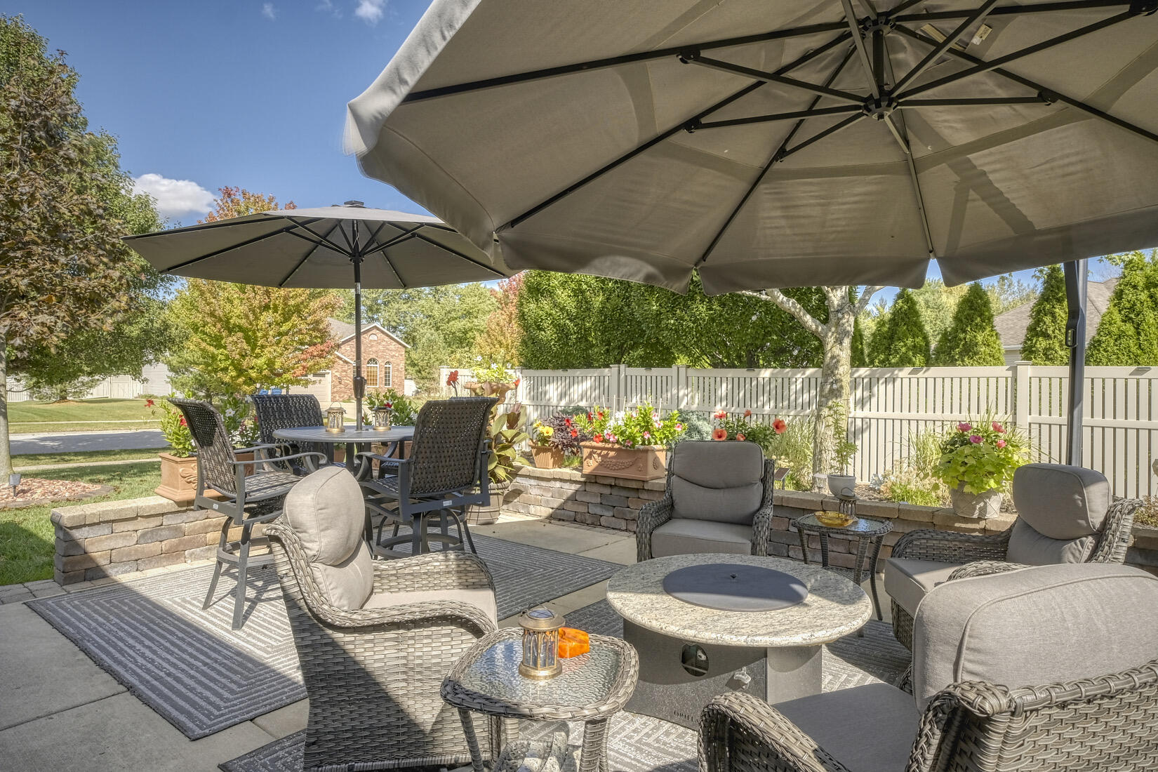 9815 Hart Street St. John, IN 46373 - Photo 4 of 19 a patio with a patio table and chairs under an umbrella