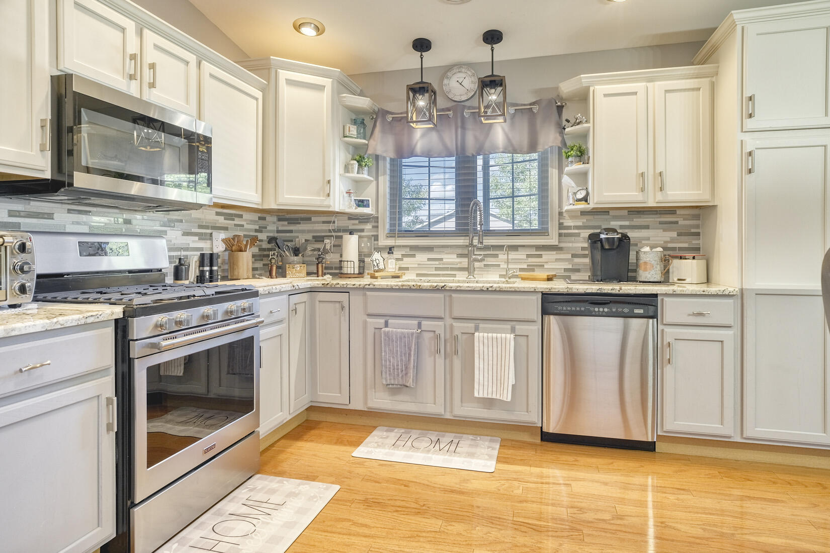 9815 Hart Street St. John, IN 46373 - Photo 9 of 19 a kitchen with stainless steel appliances granite countertop a stove a sink and a microwave