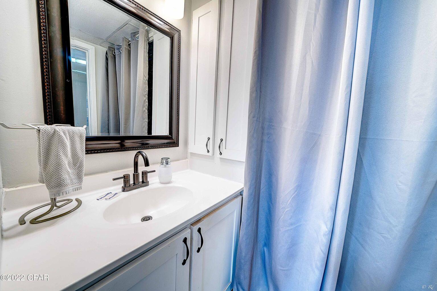 14401 Front Beach Road, Unit 434 Panama City Beach, FL 32413 - Photo 11 of 36 a bathroom with a sink and a mirror