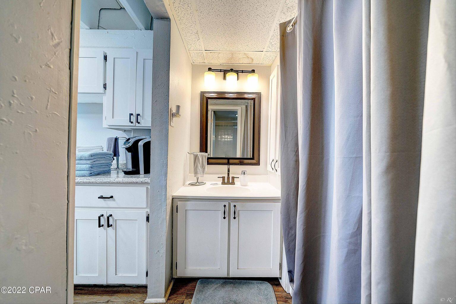 14401 Front Beach Road, Unit 434 Panama City Beach, FL 32413 - Photo 12 of 36 a bathroom with a sink and a mirror