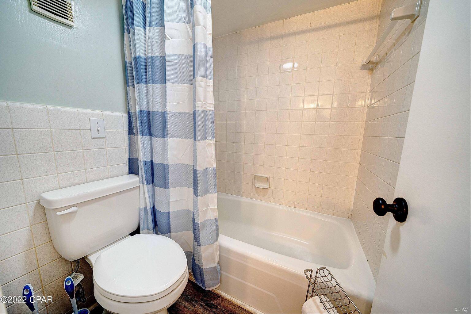 14401 Front Beach Road, Unit 434 Panama City Beach, FL 32413 - Photo 13 of 36 a white toilet sitting next to a bath tub