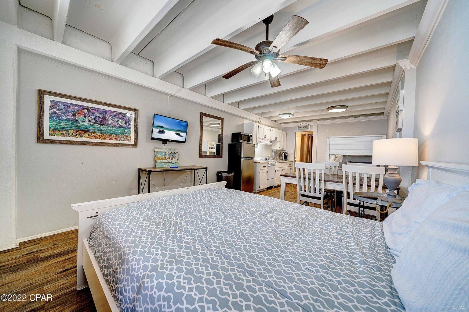 14401 Front Beach Road, Unit 434 Panama City Beach, FL 32413 - Photo 2 of 36 a bedroom with a bed and a chandelier