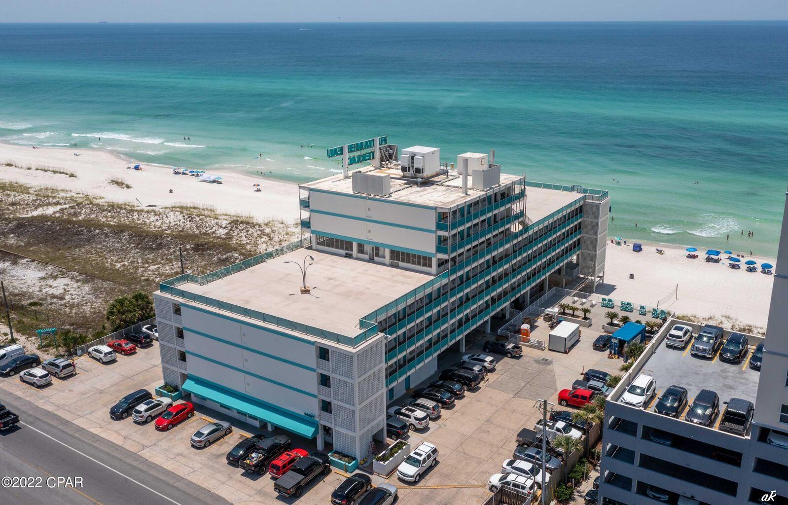 14401 Front Beach Road, Unit 434 Panama City Beach, FL 32413 - Photo 31 of 36 a terrace with a bench and lake view