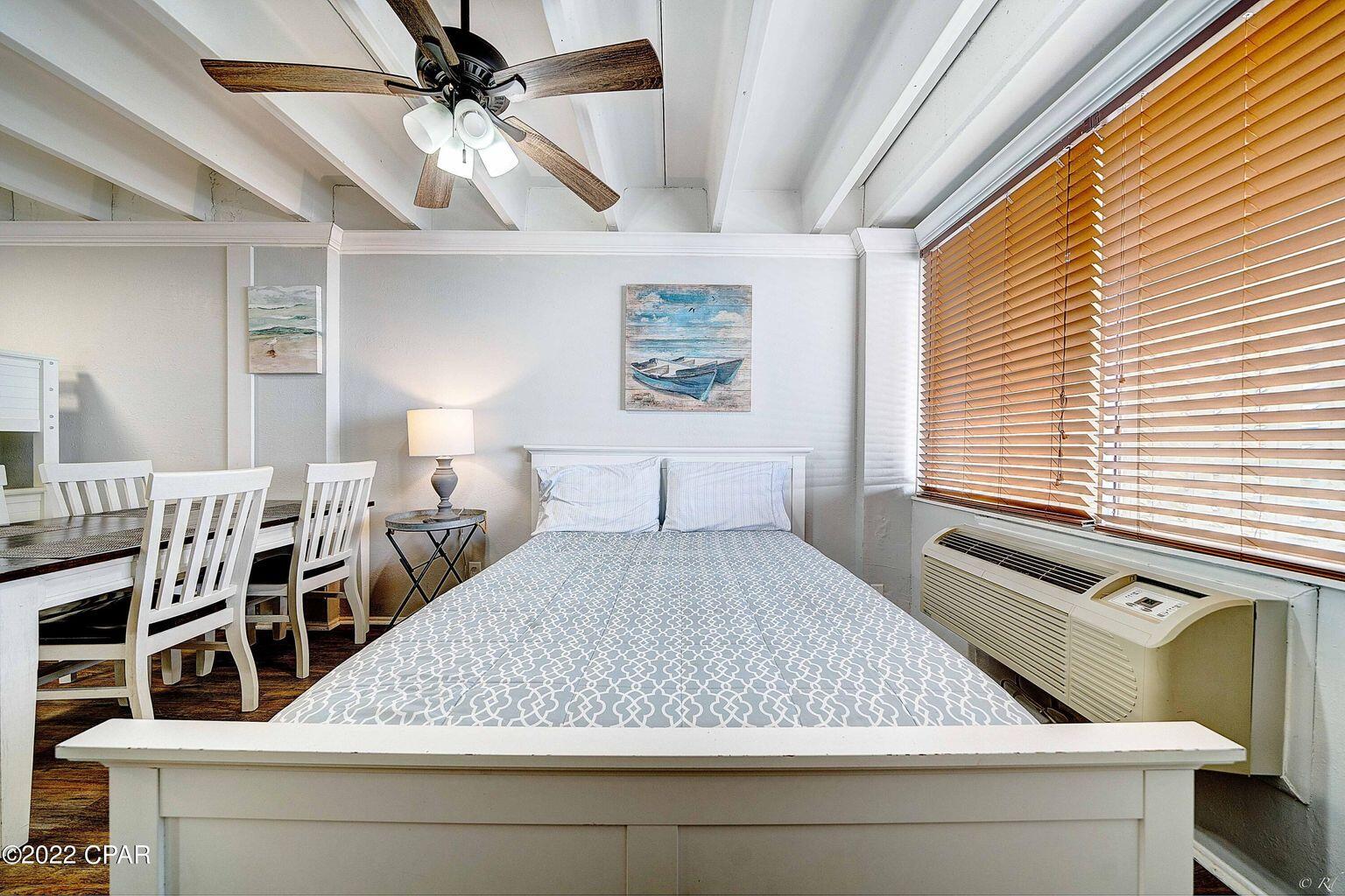 14401 Front Beach Road, Unit 434 Panama City Beach, FL 32413 - Photo 4 of 36 a bed sitting in a bedroom next to a window