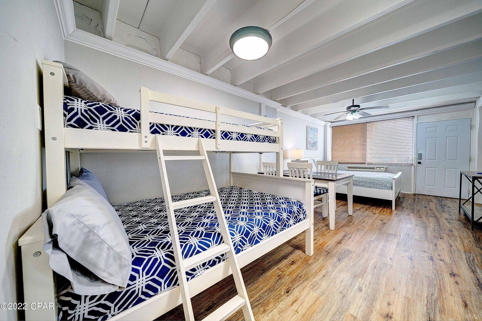 14401 Front Beach Road, Unit 434 Panama City Beach, FL 32413 - Photo 8 of 36 a living room with furniture and a wooden floor