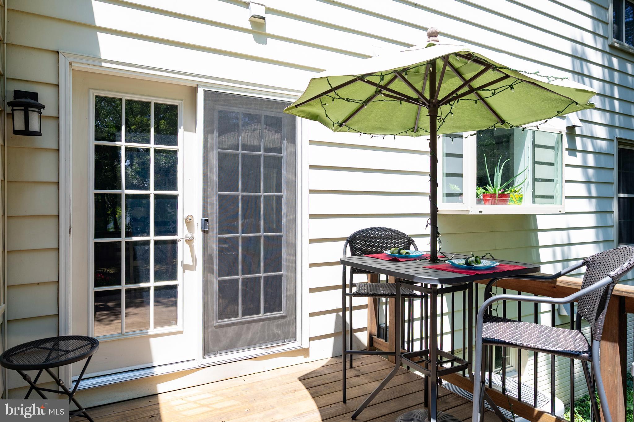 6909 Trillium Lane Springfield, VA 22152 - Photo 14 of 36 a view of a outdoor sitting area with furniture and umbrella