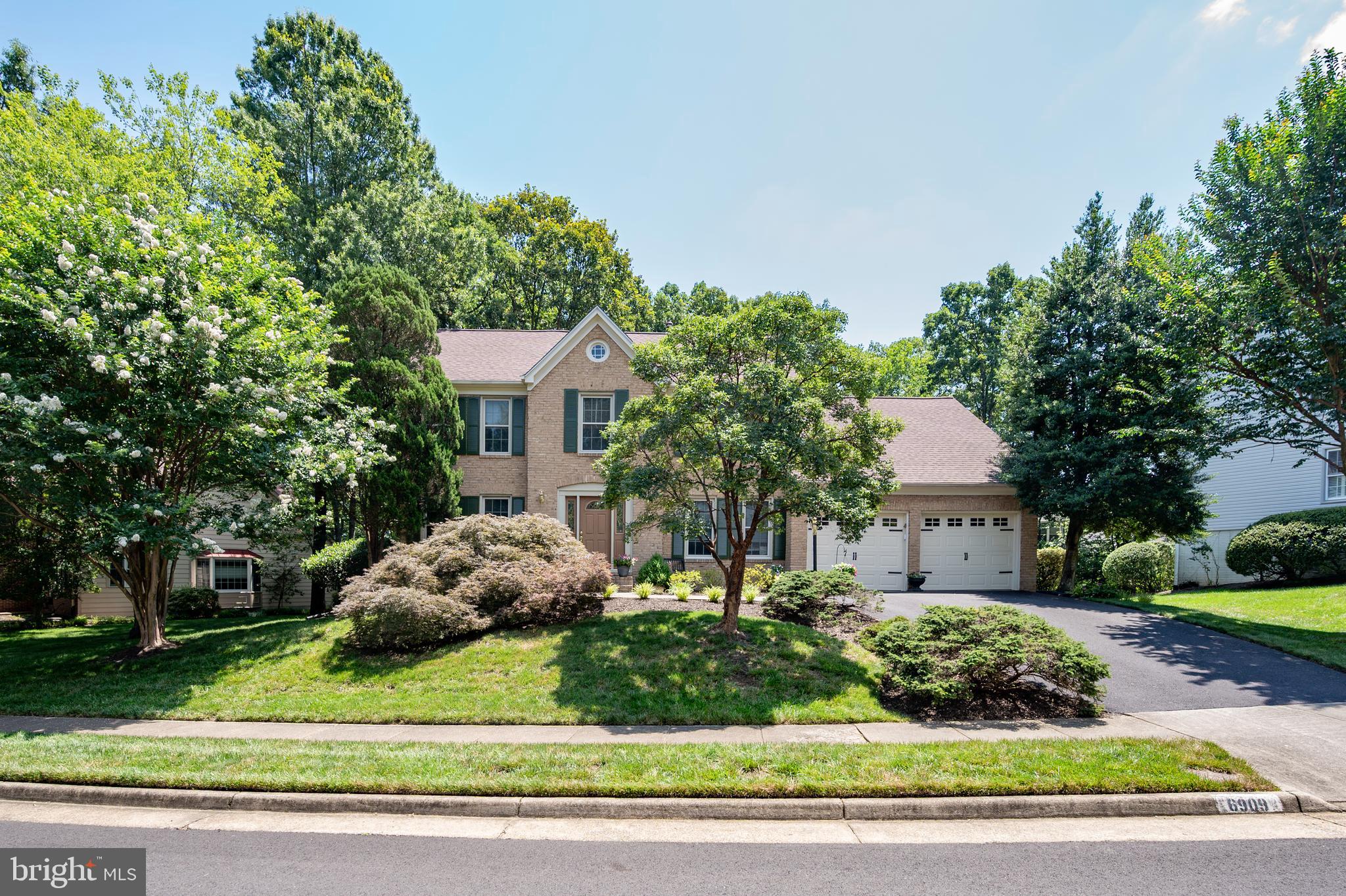 6909 Trillium Lane Springfield, VA 22152 - Photo 19 of 36 a front view of a house with a yard