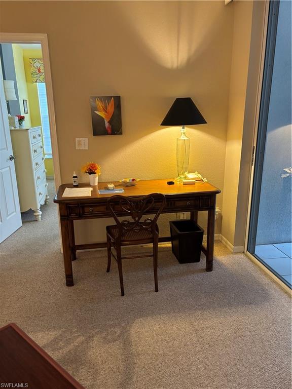 7108 Barrington Circle, Unit 101 Naples, FL 34108 - Photo 11 of 30 a table and chair in a room next to a window
