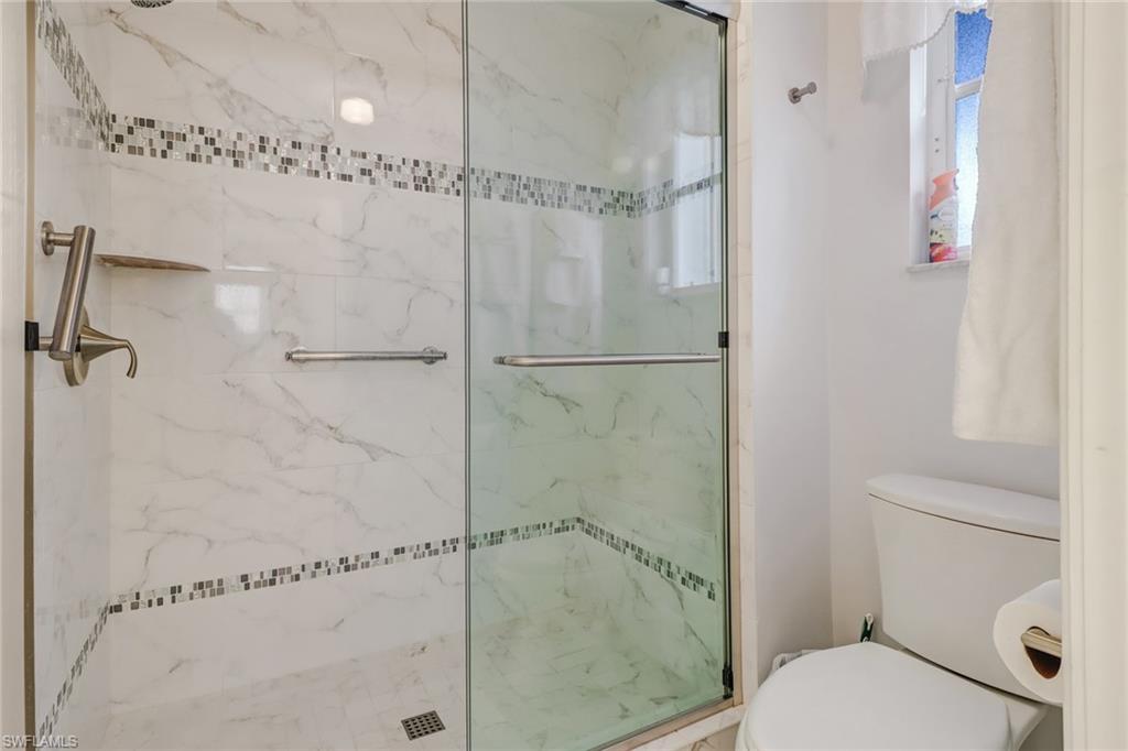 7108 Barrington Circle, Unit 101 Naples, FL 34108 - Photo 18 of 30 a bathroom with a toilet and a shower