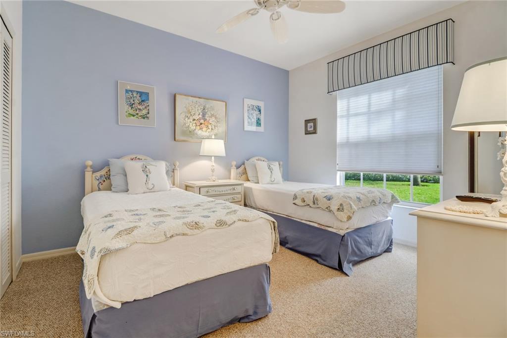 7108 Barrington Circle, Unit 101 Naples, FL 34108 - Photo 19 of 30 a bedroom with two beds and a large window