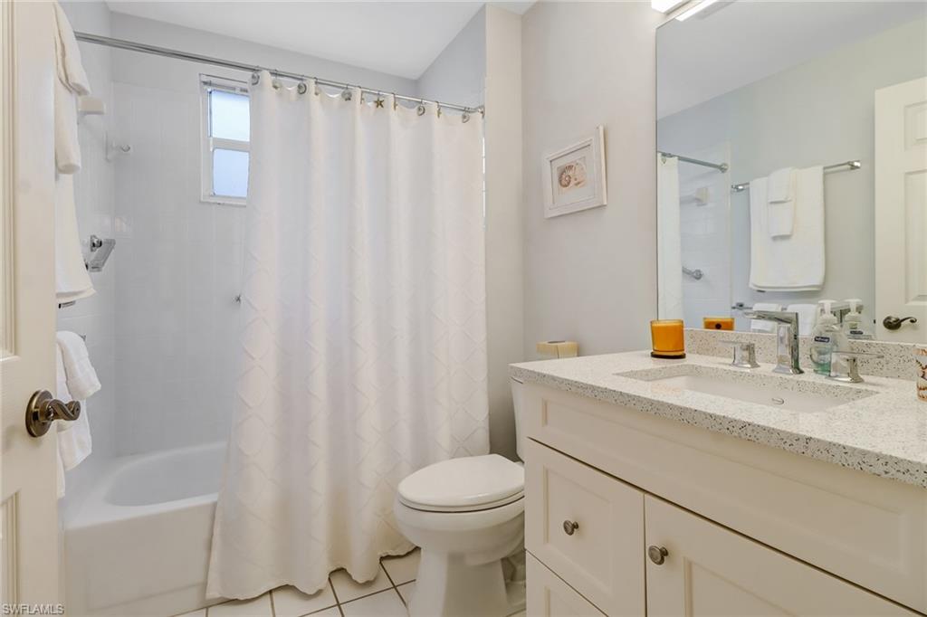 7108 Barrington Circle, Unit 101 Naples, FL 34108 - Photo 21 of 30 a bathroom with a sink a toilet and shower