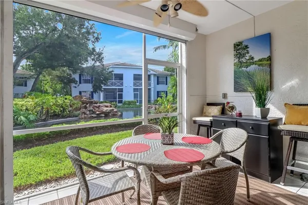 a view of a porch with furniture and a yard