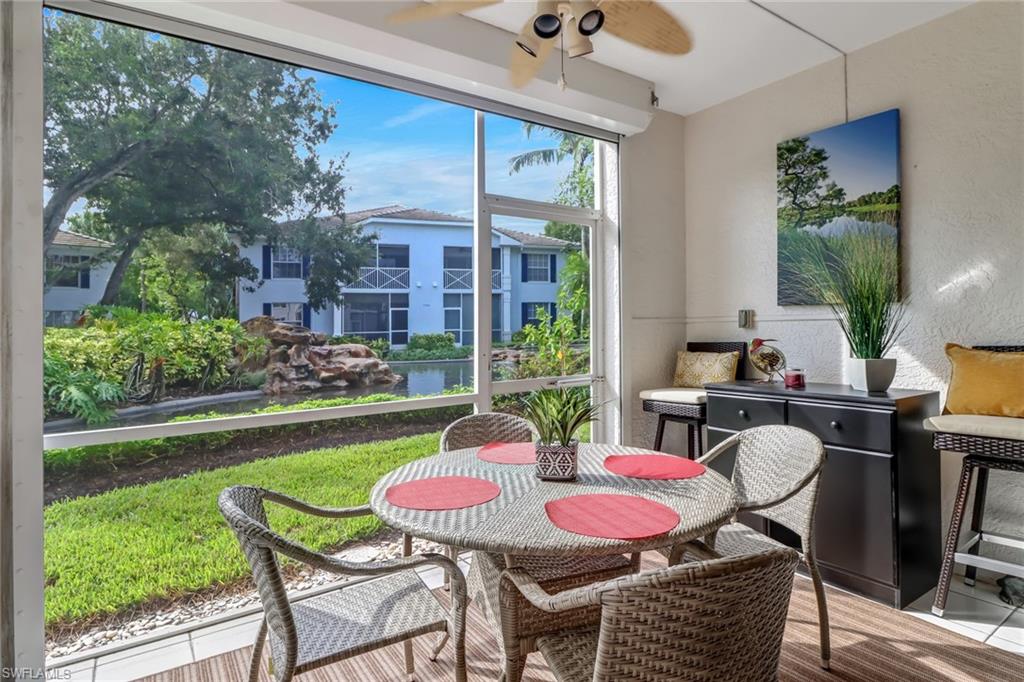 7108 Barrington Circle, Unit 101 Naples, FL 34108 - Photo 24 of 30 a outdoor dining space with furniture and garden view