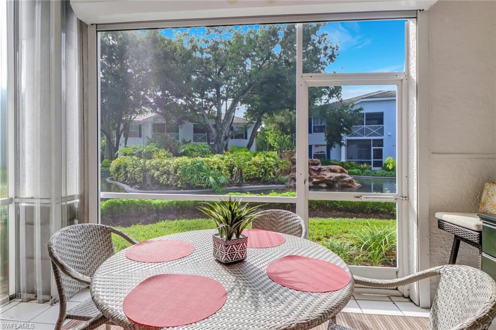 7108 Barrington Circle, Unit 101 Naples, FL 34108 - Photo 25 of 30 a view of a porch with furniture and a yard