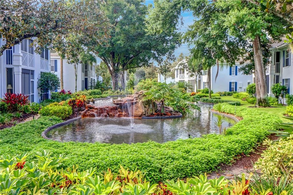 7108 Barrington Circle, Unit 101 Naples, FL 34108 - Photo 26 of 30 a swimming pool with outdoor seating and yard
