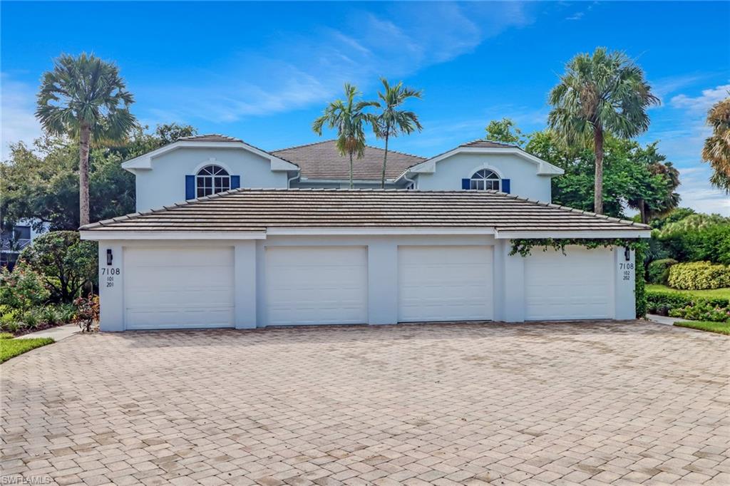 7108 Barrington Circle, Unit 101 Naples, FL 34108 - Photo 29 of 30 a front view of house with a garden