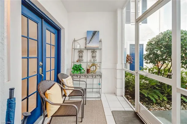 a view of a dining room with furniture and a chandelier fan
