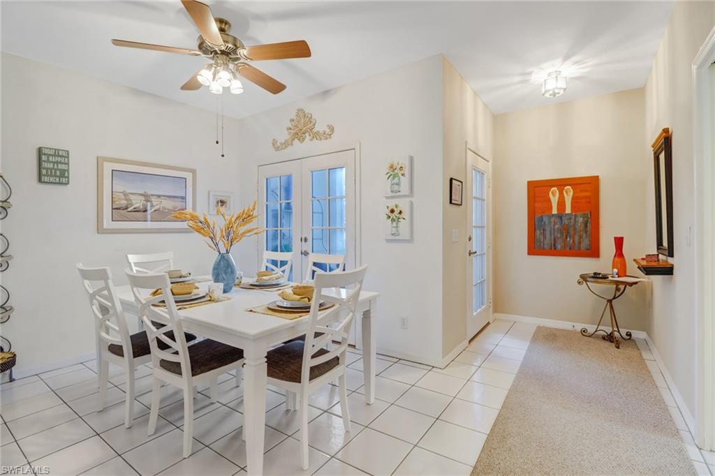 7108 Barrington Circle, Unit 101 Naples, FL 34108 - Photo 5 of 30 a view of a dining room with furniture and a chandelier fan