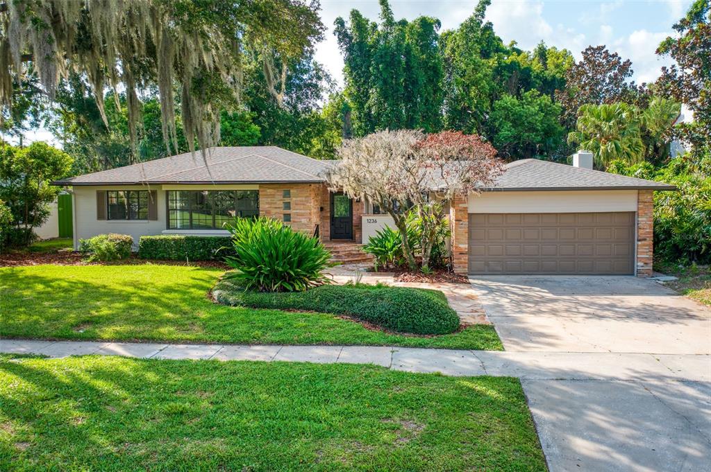 1236 Spring Lake Drive Orlando, FL 32804 - Photo 1 of 1 a front view of a house with a garden