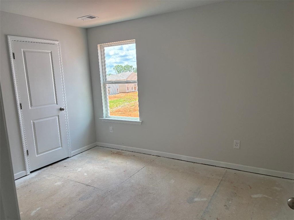 129 Cedar Shoals Easley, SC 29640 - Photo 23 of 31 A well-lit bedroom awaits personalization, offering a canvas for your ideal living space.