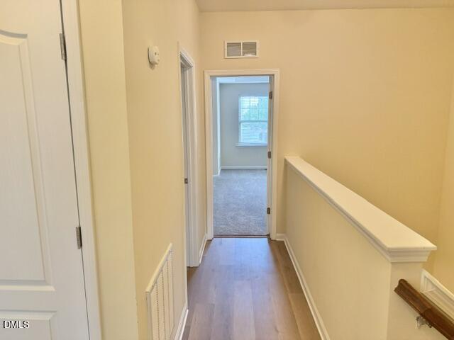 8227 Primanti Boulevard Raleigh, NC 27612 - Photo 13 of 25 a view of a hallway with wooden floor