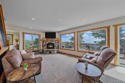 a living room with furniture and large windows